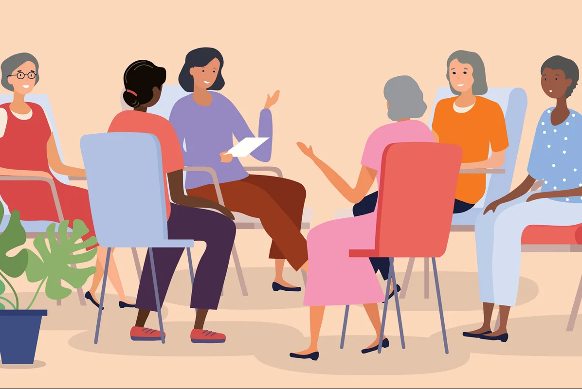 group of seniors sitting in a circle of chairs chatting