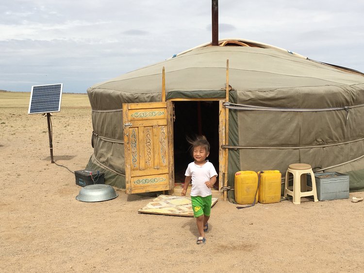 indigenous girl near solar-powered yurt